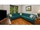 Comfortable living room featuring a large sectional sofa, hardwood floors, and natural light at 3227 Collier Gate Se Ct, Smyrna, GA 30080