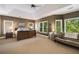 Spacious main bedroom features many windows, ceiling fan, seating area and neutral tones at 3227 Collier Gate Se Ct, Smyrna, GA 30080