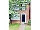 Charming brick home with black door, bay window, and manicured lawn at 401 Autumn Leaf Way, Norcross, GA 30093