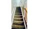Carpeted staircase with white railings leading to the upper level at 401 Autumn Leaf Way, Norcross, GA 30093