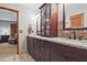 Bathroom featuring a dark wooden vanity with double sinks and a granite countertop at 4246 Loch Highland Ne Pkwy, Roswell, GA 30075