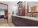 Bathroom features double vanity with granite countertop and dark wood cabinets near bedroom at 4246 Loch Highland Ne Pkwy, Roswell, GA 30075