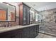 Spacious bathroom features double vanity with granite countertop and tiled walk-in shower with glass door at 4246 Loch Highland Ne Pkwy, Roswell, GA 30075
