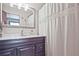 Bathroom with a granite countertop vanity and decorative shower curtain at 4246 Loch Highland Ne Pkwy, Roswell, GA 30075