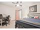 Bedroom with fan, closet, and desk, featuring a metal bed frame and comfortable carpet at 4246 Loch Highland Ne Pkwy, Roswell, GA 30075