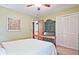 Bedroom with a bed and dresser, featuring ample natural light and closet for storage at 4246 Loch Highland Ne Pkwy, Roswell, GA 30075