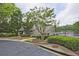 Charming clubhouse with well-maintained landscaping and a picturesque view of a serene lake at 4246 Loch Highland Ne Pkwy, Roswell, GA 30075