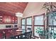 Eat-in kitchen features wood ceiling, modern lighting, and breakfast table near sunny windows at 4246 Loch Highland Ne Pkwy, Roswell, GA 30075