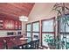 Cozy dining area features wood ceiling, matching cabinets, table set, and natural light from three windows at 4246 Loch Highland Ne Pkwy, Roswell, GA 30075