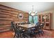 Well-appointed dining room showcasing a wooden accent wall, ample seating, and stylish decor at 4246 Loch Highland Ne Pkwy, Roswell, GA 30075