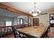 Open dining room with an elegant chandelier, wood floors, and access to the living room at 4246 Loch Highland Ne Pkwy, Roswell, GA 30075