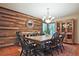 Charming dining room with a wood accent wall, chandelier, and classic furnishings at 4246 Loch Highland Ne Pkwy, Roswell, GA 30075