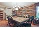 Inviting dining room featuring a decorative wood wall, a display cabinet, and hardwood floors at 4246 Loch Highland Ne Pkwy, Roswell, GA 30075