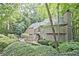 Beautiful home with a wooded lot and a partial view of the front entrance at 4246 Loch Highland Ne Pkwy, Roswell, GA 30075