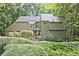Charming two-story home with wood siding, mature landscaping, and inviting curb appeal at 4246 Loch Highland Ne Pkwy, Roswell, GA 30075