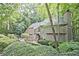 View of the home showing mature landscaping and natural surroundings at 4246 Loch Highland Ne Pkwy, Roswell, GA 30075