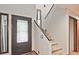 Foyer with staircase, wood floors, and decorative glass in the front door at 4246 Loch Highland Ne Pkwy, Roswell, GA 30075
