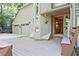 Inviting front porch leading to a charming residence with attached two car garage at 4246 Loch Highland Ne Pkwy, Roswell, GA 30075