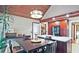 Kitchen area with wood ceiling, breakfast table, and cabinets with black appliances and a granite counter-top at 4246 Loch Highland Ne Pkwy, Roswell, GA 30075