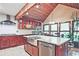 Modern kitchen with a large island, stainless steel appliances, and a vaulted wood ceiling at 4246 Loch Highland Ne Pkwy, Roswell, GA 30075
