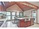 Bright kitchen with an island, stone countertops, stainless appliances, and wood beam ceiling at 4246 Loch Highland Ne Pkwy, Roswell, GA 30075