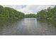 Scenic view of a calm lake surrounded by lush green trees, offering a peaceful and natural setting at 4246 Loch Highland Ne Pkwy, Roswell, GA 30075