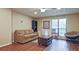 Living room with a comfortable couch and hardwood flooring, featuring a window at 4246 Loch Highland Ne Pkwy, Roswell, GA 30075
