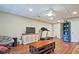 Basement living room features neutral walls, hardwood flooring and a ceiling fan at 4246 Loch Highland Ne Pkwy, Roswell, GA 30075