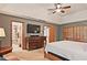 The primary bedroom boasts an ensuite bathroom, large windows, and a ceiling fan at 4246 Loch Highland Ne Pkwy, Roswell, GA 30075