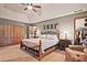 Spacious main bedroom featuring a vaulted ceiling, neutral colors, and a seating area with an upholstered chair at 4246 Loch Highland Ne Pkwy, Roswell, GA 30075