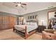 Bright main bedroom features neutral paint, ceiling fan, and seating area near closet space at 4246 Loch Highland Ne Pkwy, Roswell, GA 30075