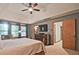 Main bedroom with ensuite bathroom, dark-wood dresser, comfortable seating area, and windows at 4246 Loch Highland Ne Pkwy, Roswell, GA 30075