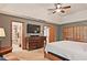 Main bedroom with an en-suite bathroom, a lounge chair and wall-mounted TV for optimal comfort at 4246 Loch Highland Ne Pkwy, Roswell, GA 30075