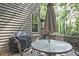 Outdoor dining space featuring a table with an umbrella and chairs, perfect for enjoying meals outdoors at 4246 Loch Highland Ne Pkwy, Roswell, GA 30075