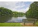 Scenic view of the pond from a bench, inviting relaxation at 4246 Loch Highland Ne Pkwy, Roswell, GA 30075
