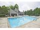 Spacious community pool with an adjacent building and comfortable seating areas, ideal for social gatherings at 4246 Loch Highland Ne Pkwy, Roswell, GA 30075
