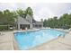 Inviting swimming pool with a clubhouse and deck chairs, perfect for relaxation and recreation at 4246 Loch Highland Ne Pkwy, Roswell, GA 30075