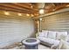Cozy screened porch with string lights, a ceiling fan, and comfortable seating around a fire pit table at 4246 Loch Highland Ne Pkwy, Roswell, GA 30075