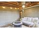 Relaxing screened porch featuring a stylish sofa and rustic decor at 4246 Loch Highland Ne Pkwy, Roswell, GA 30075