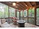 Relaxing sunroom with comfortable seating and views of the surrounding trees at 4246 Loch Highland Ne Pkwy, Roswell, GA 30075