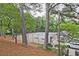 Well-maintained tennis courts surrounded by trees, with players enjoying a match on a sunny day at 4246 Loch Highland Ne Pkwy, Roswell, GA 30075