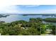 Stunning aerial shot shows a lakeside property surrounded by lush greenery and tranquil waters, offering serenity at 5340 Young Deer Dr, Cumming, GA 30041