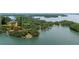 An aerial view of a lakefront property with mature trees and boat docks on a sunny day at 5340 Young Deer Dr, Cumming, GA 30041