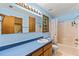 A bright blue bathroom is featured with a large mirror and a shower with a butterfly shower curtain at 5340 Young Deer Dr, Cumming, GA 30041