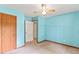 This light blue bedroom has multiple doorways, a ceiling fan, and a large window for natural light at 5340 Young Deer Dr, Cumming, GA 30041