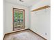 This is a cozy bedroom with a window that provides natural light and a simple shelf for storage at 5340 Young Deer Dr, Cumming, GA 30041