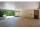 Inside view of the carport featuring a concrete slab, door entrance and access to the driveway at 5340 Young Deer Dr, Cumming, GA 30041