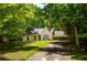 Charming one-story home with a well-maintained lawn and mature trees surrounding the property at 5340 Young Deer Dr, Cumming, GA 30041