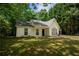 Charming one-story home with a well-maintained lawn and mature trees surrounding the property at 5340 Young Deer Dr, Cumming, GA 30041