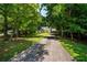 Charming one-story home with a well-maintained lawn and mature trees surrounding the property at 5340 Young Deer Dr, Cumming, GA 30041